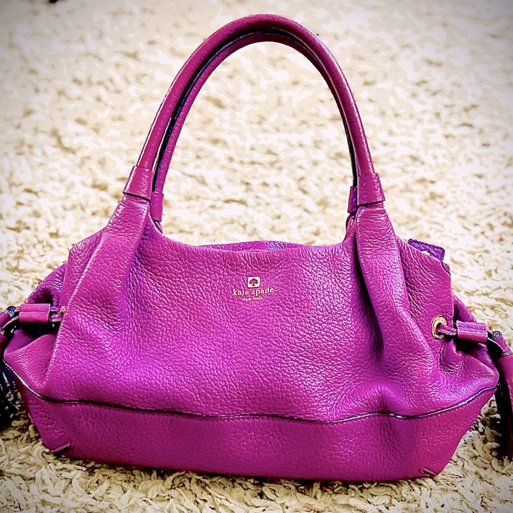 Kate Spade purple purse with tassels.